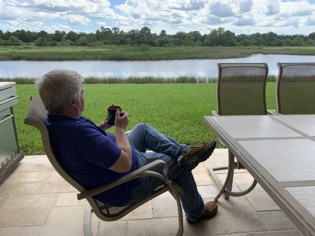 Chris, a Port St Lucie Real Estate Agent, drinks his coffee overlooking the wilderness preserve behind a Port St Lucie Home.