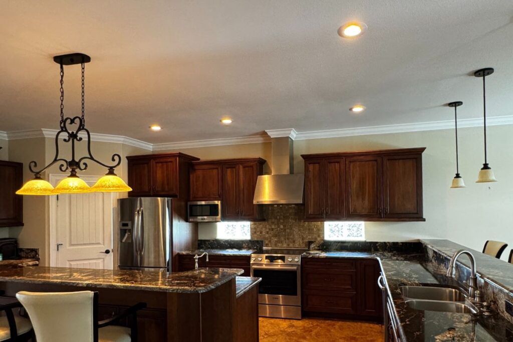 Real estate agent meeting a home seller at the kitchen table to review documents calmly